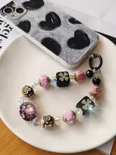 豪華な水晶ディテールの幸運花モチーフのカメラストラップ【手作り・ビーズチェーン・デザイン性高い】