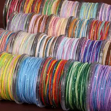 手作りのコットン糸で編まれた流しのタッセルブレスレット【耐久性のある段染め・金糸入り】