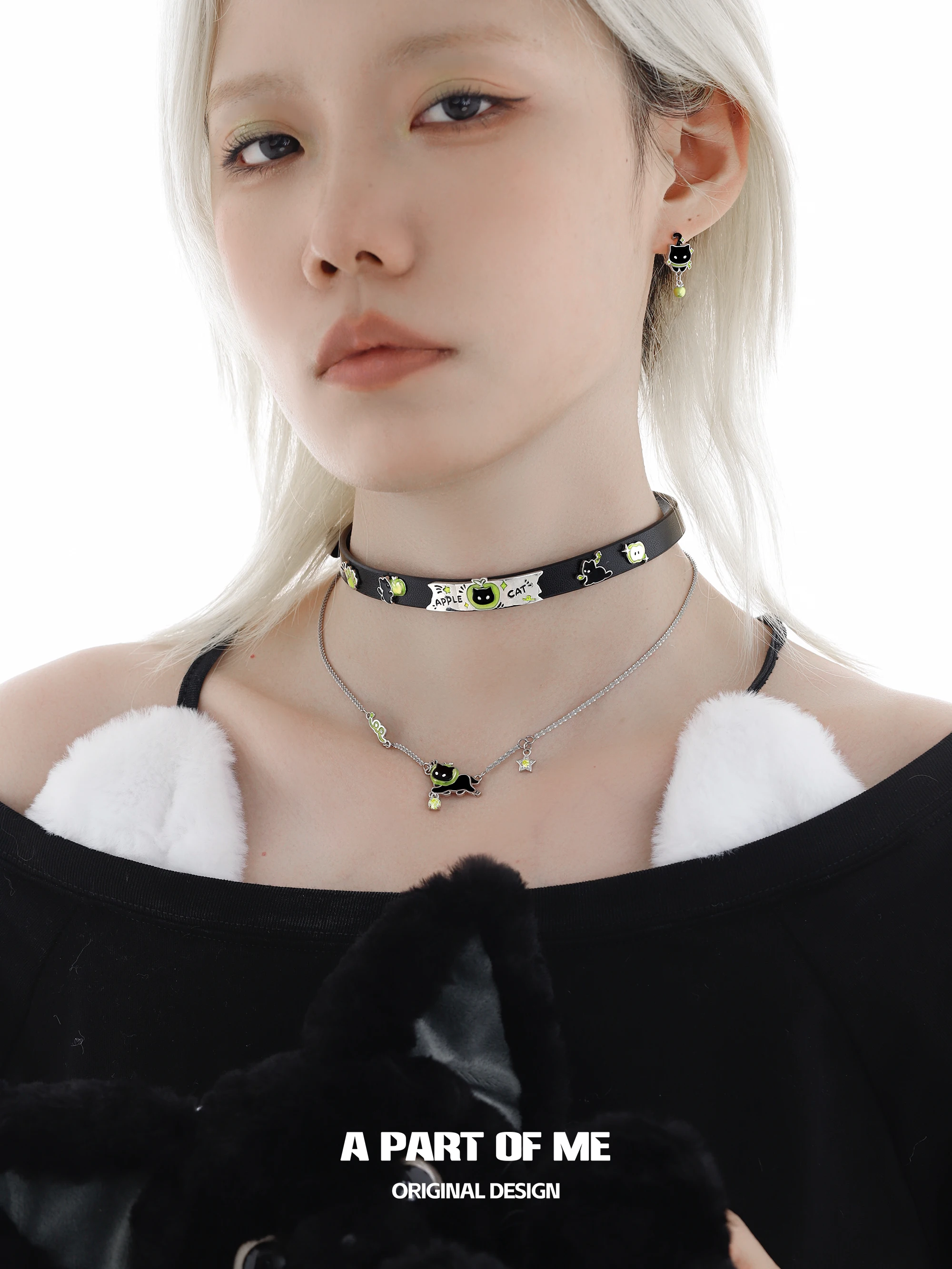 Y2Kスタイルに欠かせないアクセサリーは？黒猫と青リンゴの重ね付けネックレスが答えになる
