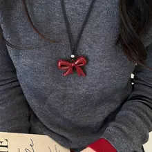 愛らしいリボンデザインのハートネックレス【長めの黒紐・お洒落なニットアクセサリー】