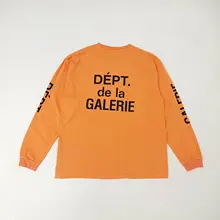 オレンジ色のゆったりとした長袖Tシャツ【ヴィンテージ風・ウォッシュ加工】