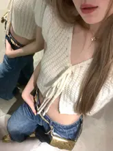 春の涼しさを感じる透かしデザインのリボン付きカーディガン【フィット感のある短丈ニット】