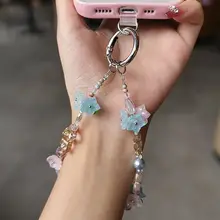 個性的なスズランの花デザインのスマホストラップ【高級感あるビーズ付き・女性向け・防止用】