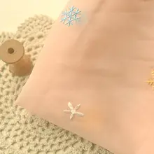 淡い杏色と粉色の雪花模様ポリエステル生地【ドレス用・長袖・ガーゼ風】