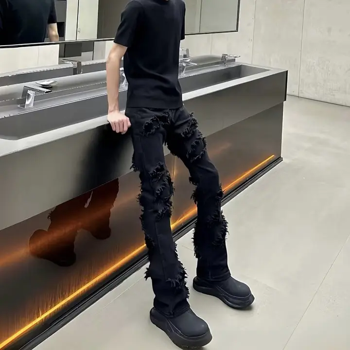 洗い加工された黒のフリンジ付きダメージデニムパンツ【スリムフィット・マイクロブーツカット】