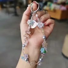 個性的なスズランの花デザインのスマホストラップ【高級感あるビーズ付き・女性向け・防止用】