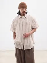 NOEARS 夏らしい若々しい気分を演出するアプリコットカラーの縦縞 シャツ